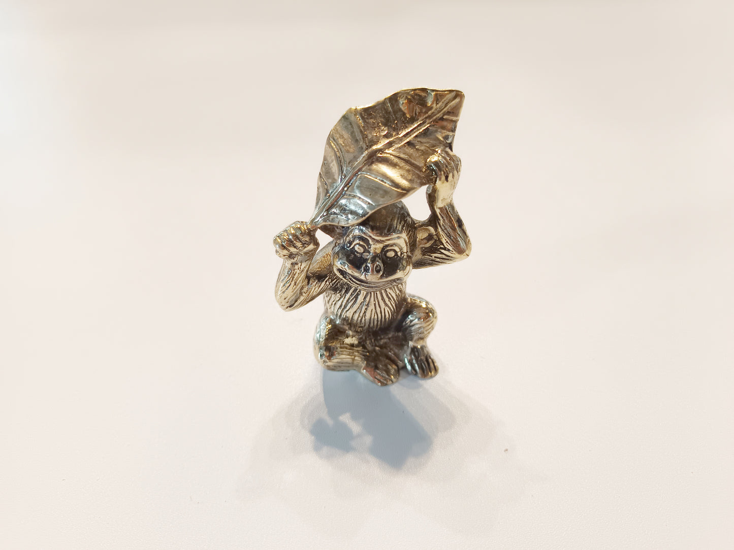 Monkey brass figurine, antique brass ape with leaf miniature